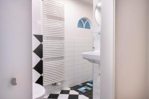 a white bathroom with a sink and a toilet at B&B Reveille in Kleve +37 photos
