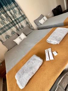a bed with two towels on top of it at Dhruvanish Grand in Sringeri