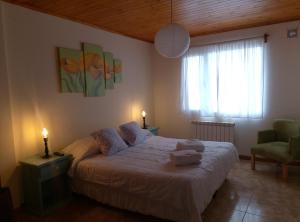 a bedroom with a bed with a teddy bear on it at avellaneda suites in Río Gallegos