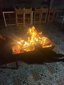 a fire pit in the middle of a room at taghoba surf house in Tamraght Ouzdar