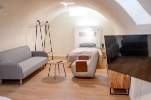 a bedroom with a bed and a couch in a room at Pension Elisa in Bad Friedrichshall
