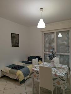 a bedroom with a bed and a table and chairs at Il Centro Apartments 3 in Salsomaggiore Terme