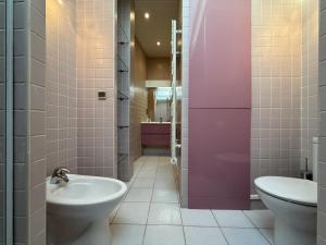 a bathroom with a toilet and a sink at Bigarena in Hendaye +22 photos