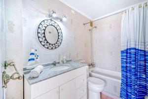 a bathroom with a sink and a toilet and a tub at Costa Azul- 3D Seafront Apartment in Algarrobo +8 photos