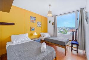 a hotel room with two beds and a window at Costa Azul- 3D Seafront Apartment in Algarrobo