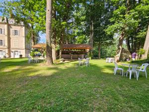 a group of tables and chairs in a park at Château de MontSablé in Lezoux +20 photos