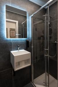 a bathroom with a sink and a shower at MSK The Whiteley in London +36 photos