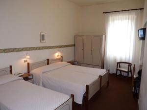 מיטה או מיטות בחדר ב-Hotel Giardinetto