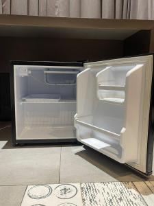 an empty refrigerator with its door open in a kitchen at KB MARINA PARk in Chennai