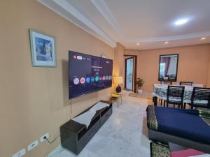 a living room with a large flat screen tv on the wall at Luxury home tunisia mall lac 2 in Tunis +3 photos