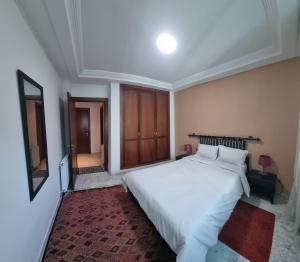 a bedroom with a large white bed in it at Luxury home tunisia mall lac 2 in Tunis