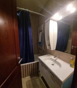 a bathroom with a sink and a blue shower curtain at Luxury home tunisia mall lac 2 in Tunis