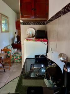 a kitchen with a stove and a counter top at Charmoso studio em Tiradentes in Tiradentes