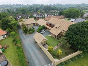 an aerial view of a house with a car parked in the driveway at FIG TREE HOUSE Entire holiday home, self catering, 4 bedroom, 2 bathroom, deck and garden in Durban