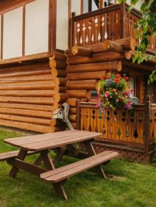 a wooden picnic table sitting in front of a house at Great Northern Resort in West Glacier