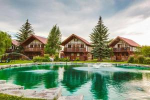 a large pool in front of a house at Great Northern Resort in West Glacier