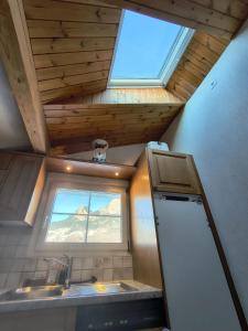 a small kitchen with a sink and a window at Ferienwohnung mit Herz in Schwyz