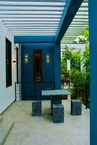 a blue building with a bench and a table at Ayana Resort Wilpattu in Wilpattu