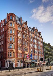 a large red brick building on the corner of a street at Thistle London Bloomsbury Park in London