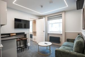 a living room with a couch and a table at MSK The Whiteley in London