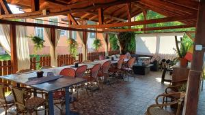 a patio with tables and chairs in a building at Casa Pelerinului in Bogata