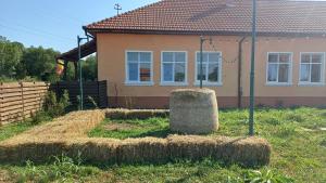 a house with hay bales in front of it at Casa Pelerinului in Bogata +24 photos
