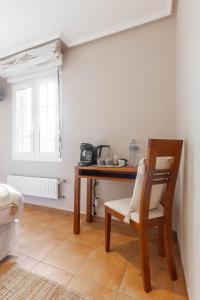 a room with a table and a chair and a table and a table at Habitaciones Guriezo in El Puente