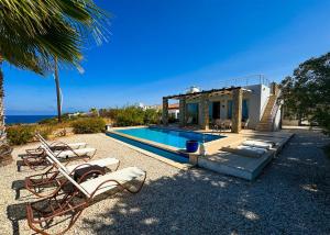 a villa with a swimming pool and a house at Villa Sea View in Kyrenia