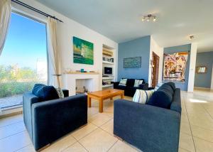 a living room with two blue couches and a fireplace at Villa Sea View in Kyrenia