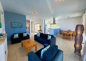 a living room with blue couches and a table at Villa Sea View in Kyrenia
