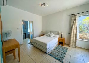 a bedroom with a bed and a desk and a window at Villa Sea View in Kyrenia +18 photos