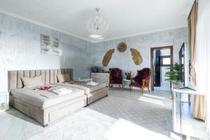 a bedroom with a bed and a table and chairs at Adonis Resort & Spa in Egina +194 photos