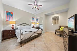 a bedroom with a bed and a ceiling fan at Turquoise Place Beachside Retreat in Orange Beach