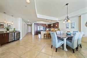 a kitchen and dining room with a table and chairs at Turquoise Place Beachside Retreat in Orange Beach