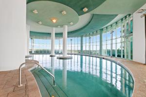 a swimming pool in a building with glass windows at Turquoise Place Beachside Retreat in Orange Beach