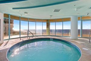 a hot tub in a room with large windows at Turquoise Place Beachside Retreat in Orange Beach +97 photos
