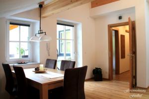 a dining room with a wooden table and chairs at Fitzlhof in Sankt Koloman