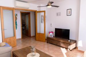 a living room with a flat screen tv and a couch at Casa LoIa Altea By DelucaCo in Altea