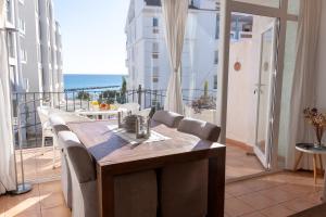 a balcony with a table and chairs and the ocean at Casa LoIa Altea By DelucaCo in Altea