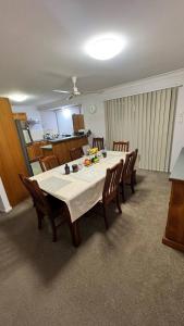 a room with a table with chairs and a kitchen at Cozy Quiet Beach room R2 in Brighton