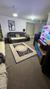 a living room with a couch and a tv at Cozy Quiet Beach room R2 in Brighton