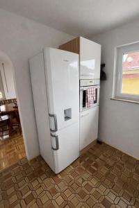 a kitchen with a white refrigerator and an oven at Pension am Heckenacker in Rothenburg ob der Tauber +22 photos