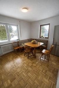 a dining room with a wooden table and chairs at Pension am Heckenacker in Rothenburg ob der Tauber