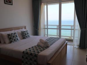 a bedroom with a bed with a view of the ocean at Beach Front 2 by A & A Villas in Uswetakeiyawa +33 photos