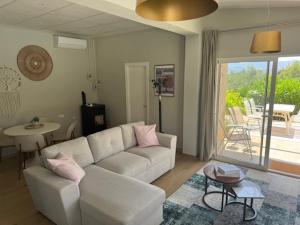 a living room with a white couch and a table at Atidos vakantie appartementen in Ontinyent
