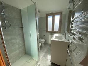 a bathroom with a shower and a sink and a toilet at Da Gin in Bosa Marina +16 photos