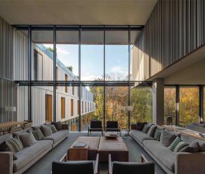 a large room with couches and tables and windows at ARIMA Hotel & Spa - Small Luxury Hotels in San Sebastián
