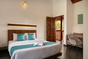 a bedroom with a bed with a dog laying on it at Punarjeevani Ayurvedic Heritage in Vythiri