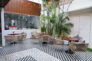 a patio with tables and chairs on a tiled floor at New Hotel Suhail in Hyderabad