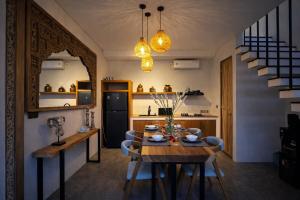 a kitchen and dining room with a table and chairs at 2BR Villa Surrounded by Rice Fields Cemagi in Cemagi